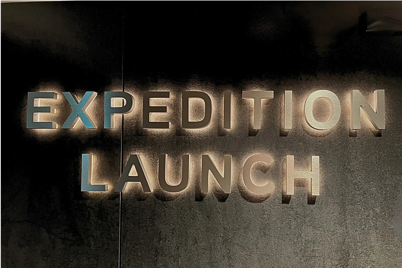 Backlit metal letters reading 'Expedition Launch' aboard the Roald Amundsen.