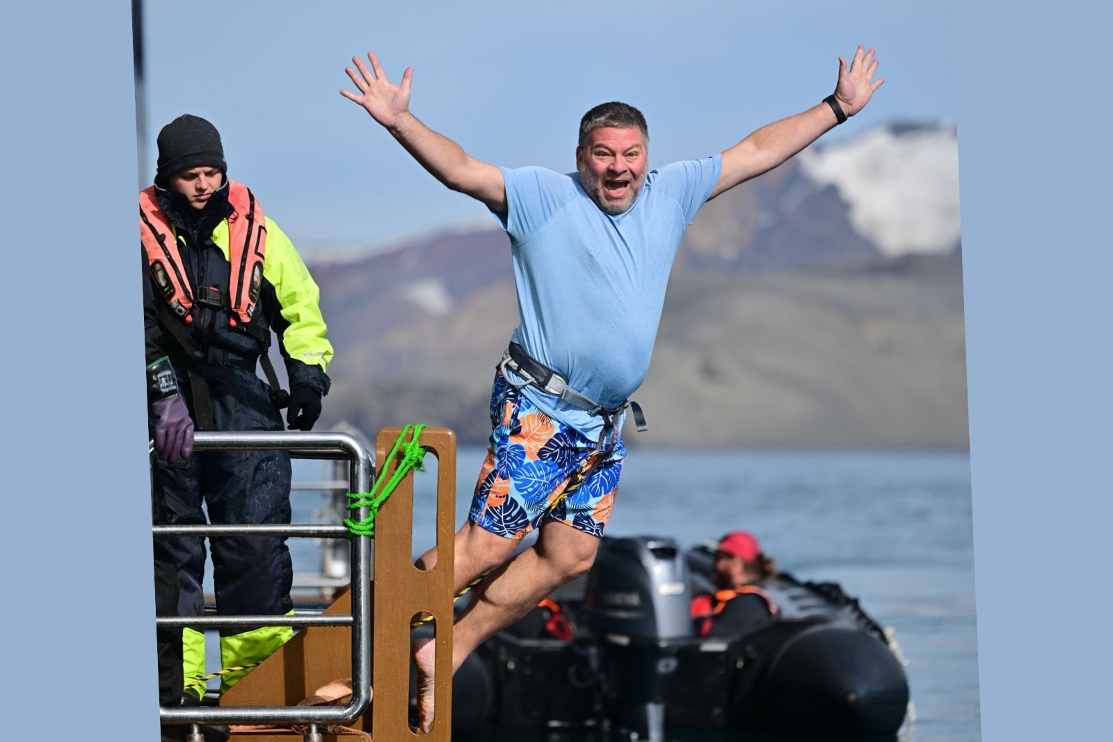 Chris Commisso jumping from a platform into Antarctic water during the polar plunge.