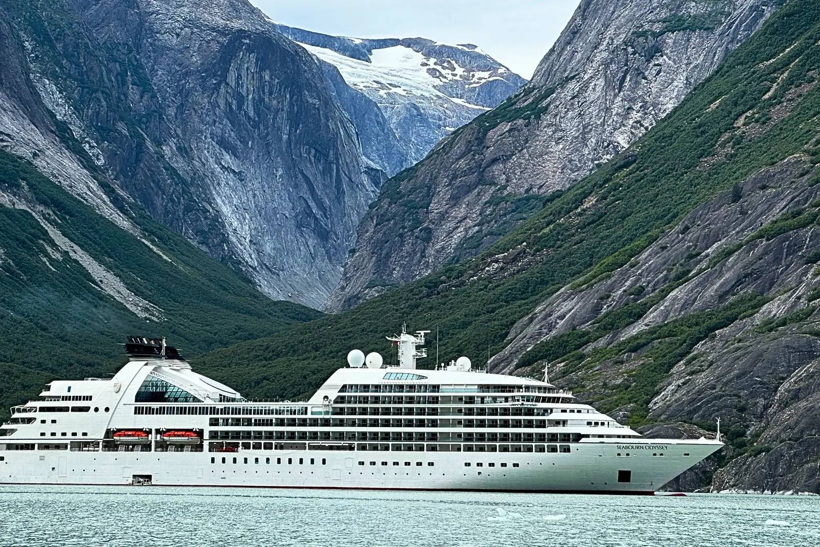 Seabourn Odyssey in Endicott Arm, below steep granite walls and a glacier-filled valley.