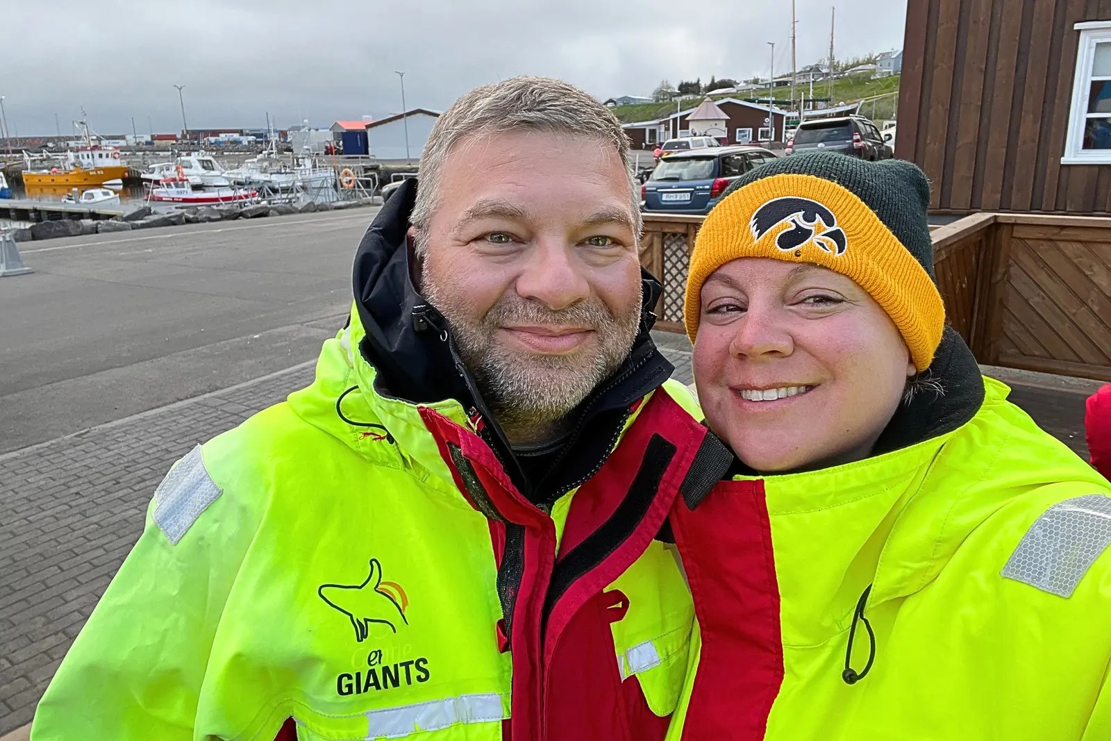 Chris and Erika Commisso in bright yellow and red whale-watching suits at the harbor in Húsavík.