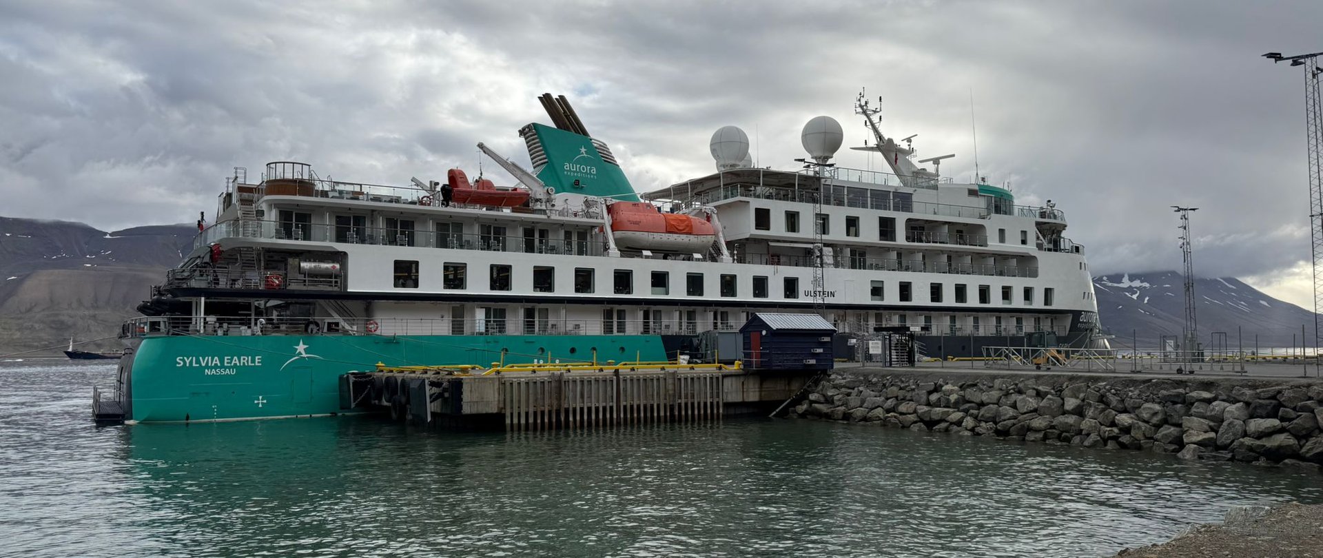 Aurora Expeditions' Sylvia Earle docked in Longyearbyen, Svalbard, showing its distinctive Ulstein X-BOW hull.