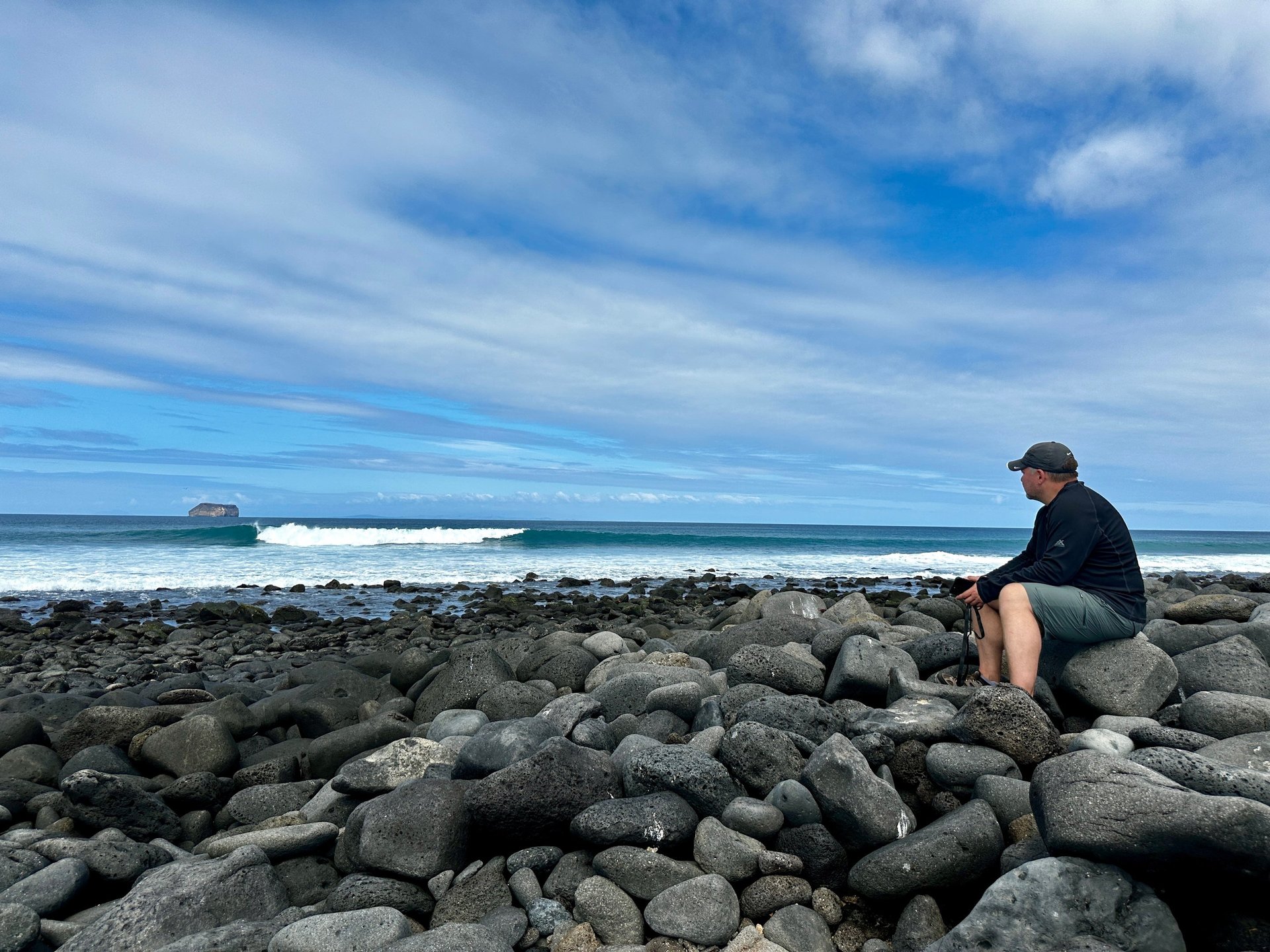 Rocky Galápagos shoreline of rounded volcanic boulders, the kind of terrain walked on a dry landing