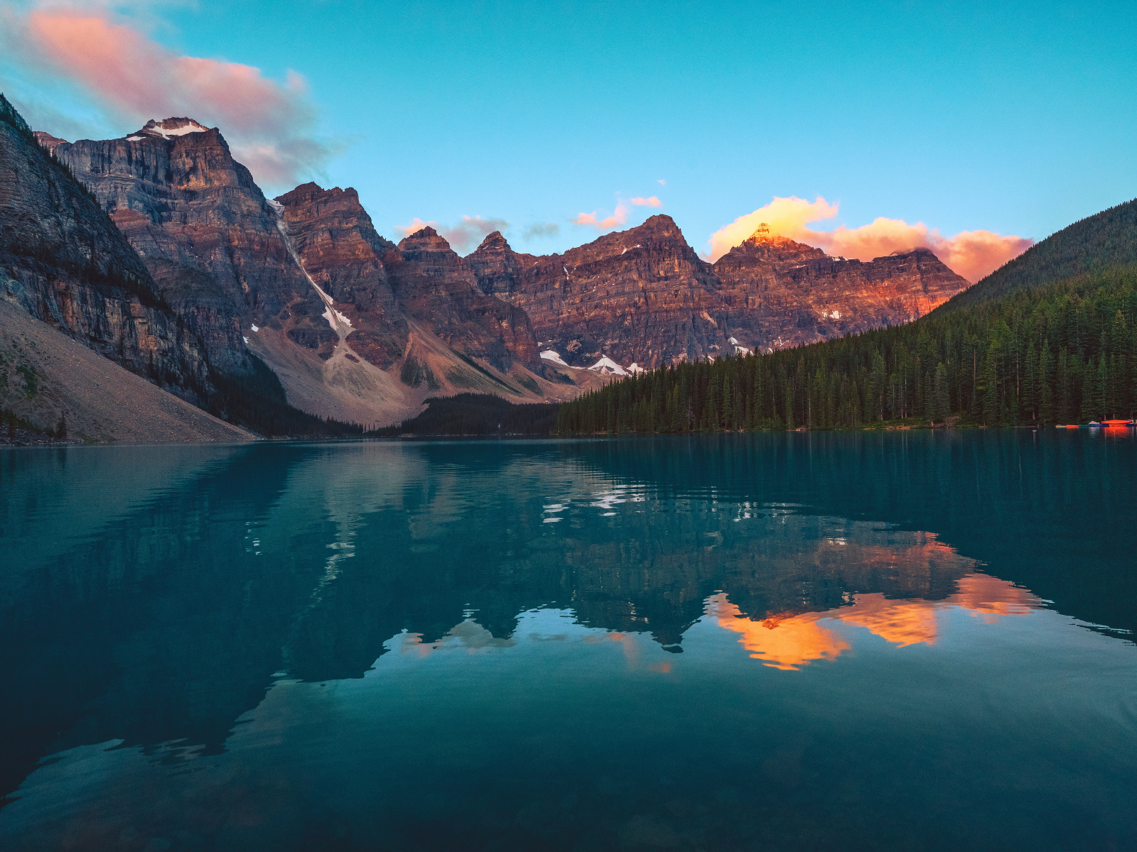 Moraine Lake in Banff National Park, with turquoise water below rugged Canadian Rockies peaks.