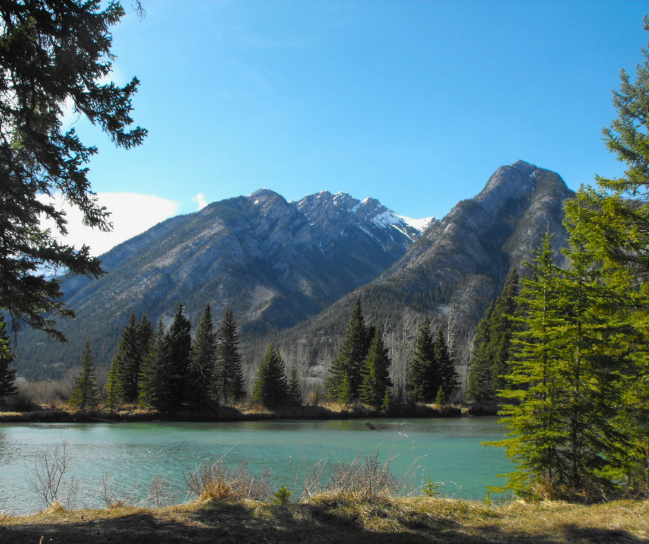A wide valley in Banff National Park beneath snow-dusted peaks.