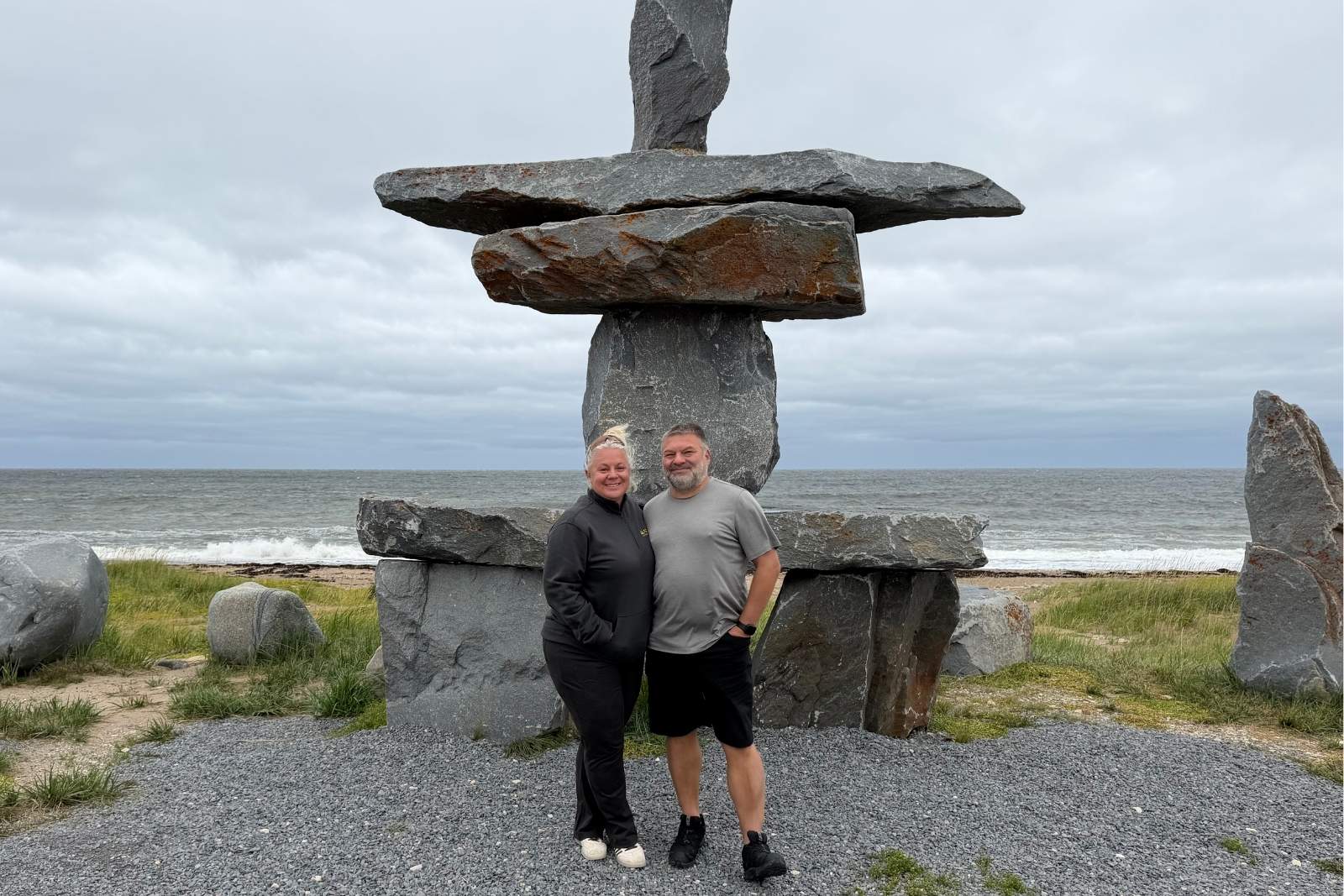 Chris and Erika Commisso at the inukshuk on the shore of Hudson Bay in summer.