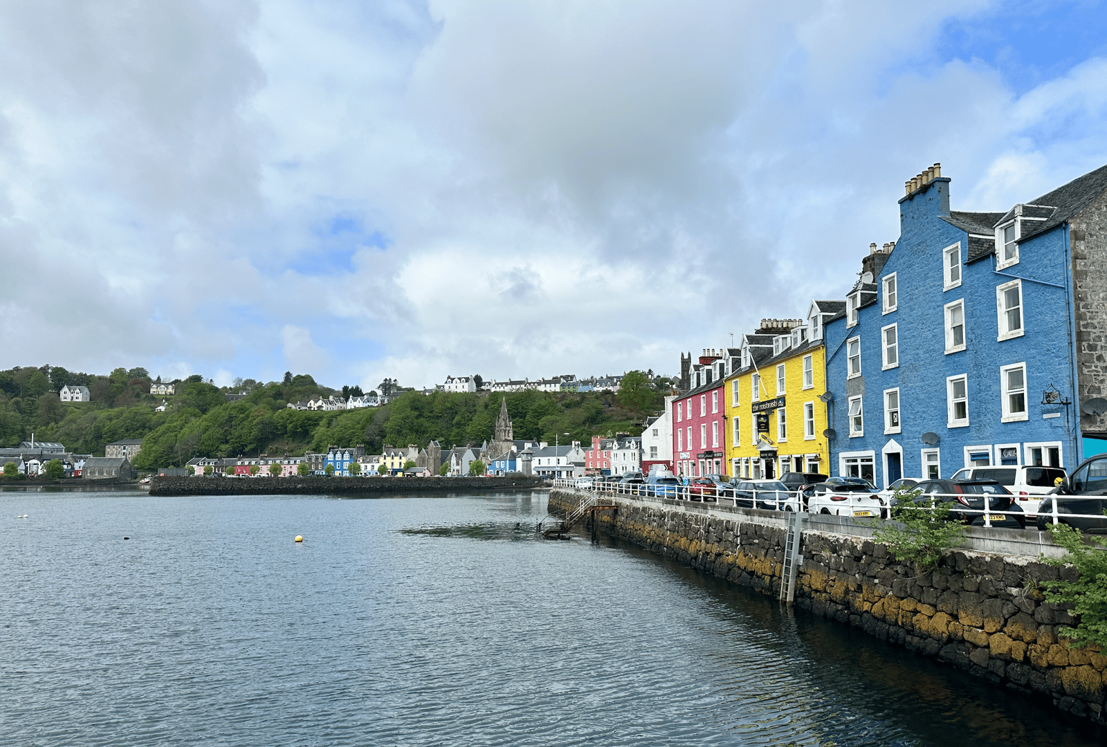 The whitewashed waterfront of an Islay distillery village along the Three Distilleries Pathway.
